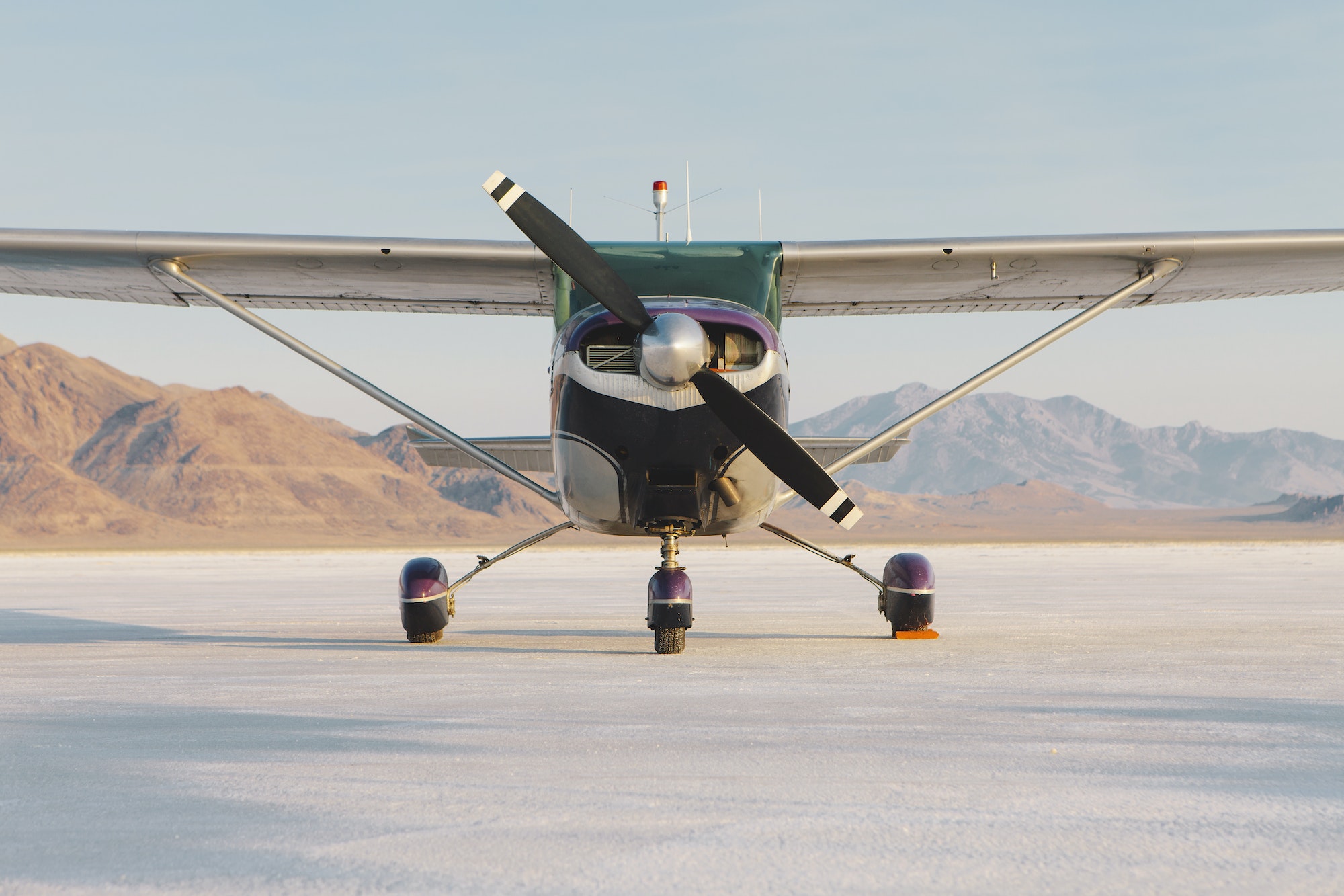 Small airplane parked on salt flats at Bonneville in Utah.